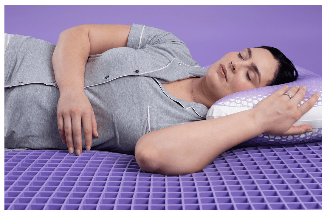 Woman sleeping on purple pillow and mattress