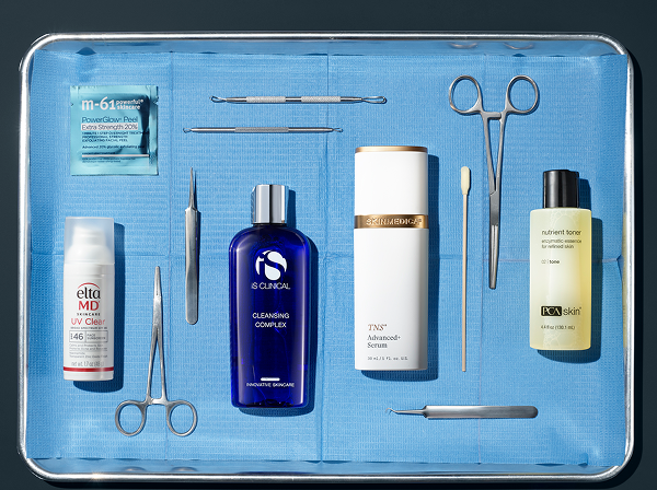 an image of assorted professional skincare products laying down on a surgical tray alongside assorted surgical tools