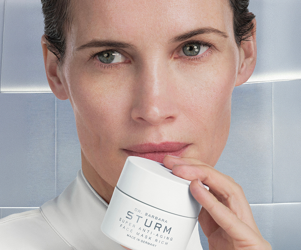 model holding the new super anti aging face mask rich