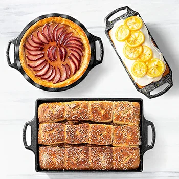 Cast iron bakeware filled with bread, pie, and lemon dessert