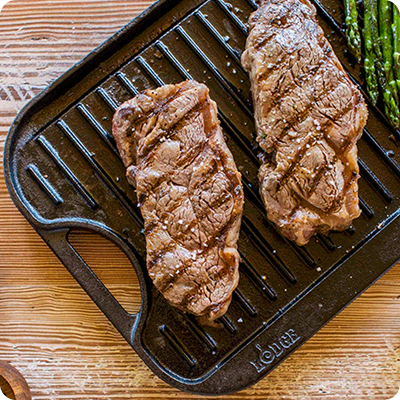 Perfectly seared meat on a cast iron griddle
