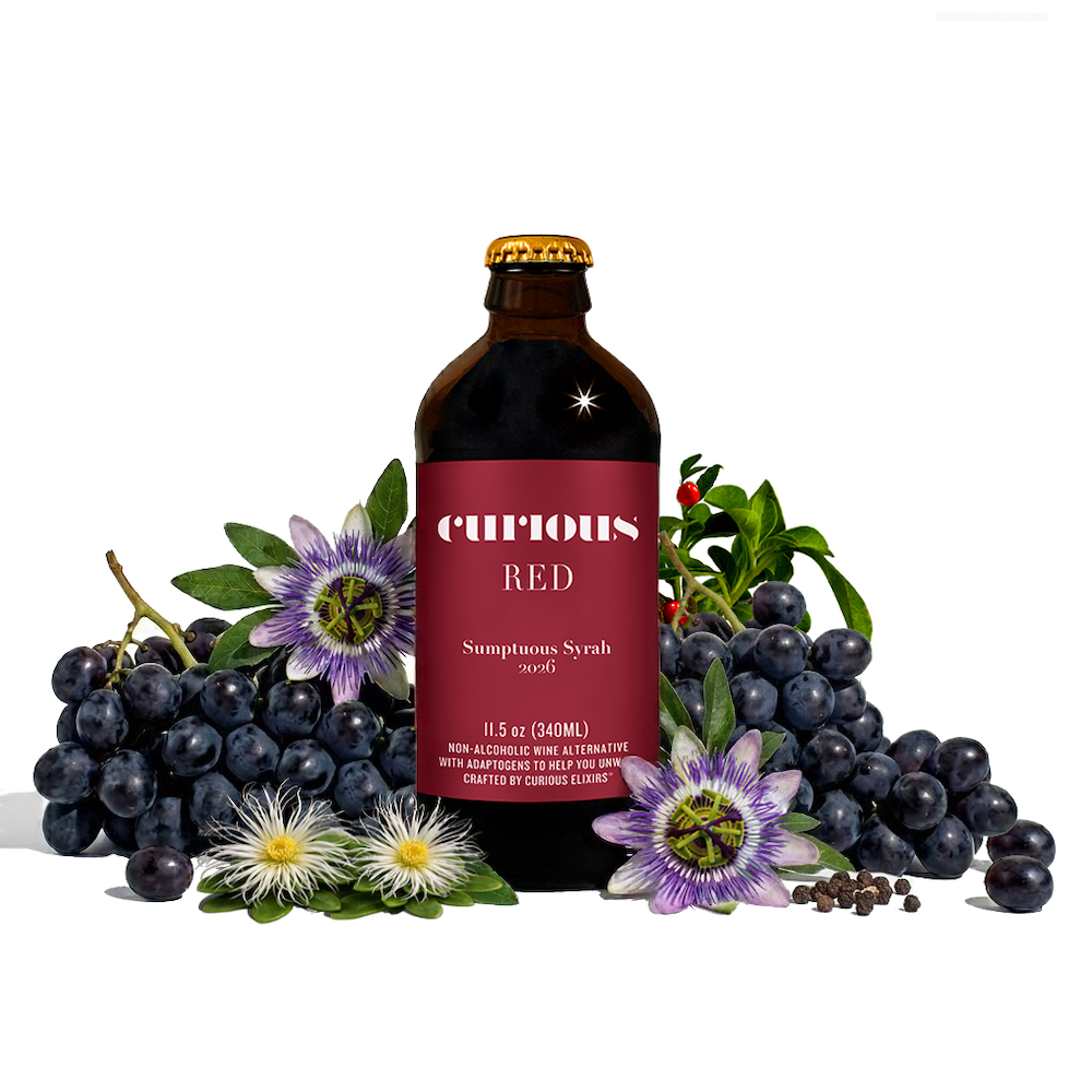 Bottle of Curious Red surrounded by ingredients